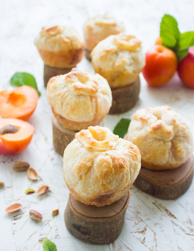 side view of Easy Whole Apricot and Peach Pies presented on little pieces of wood