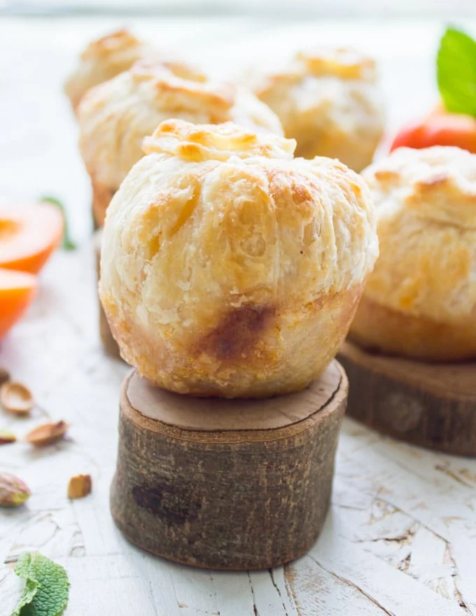 close-up of a whole apricot pie wrapped in pie pastry with a pastry flower on top