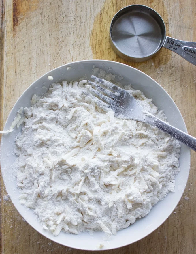 pie crust ingredients being mixed in a bowl