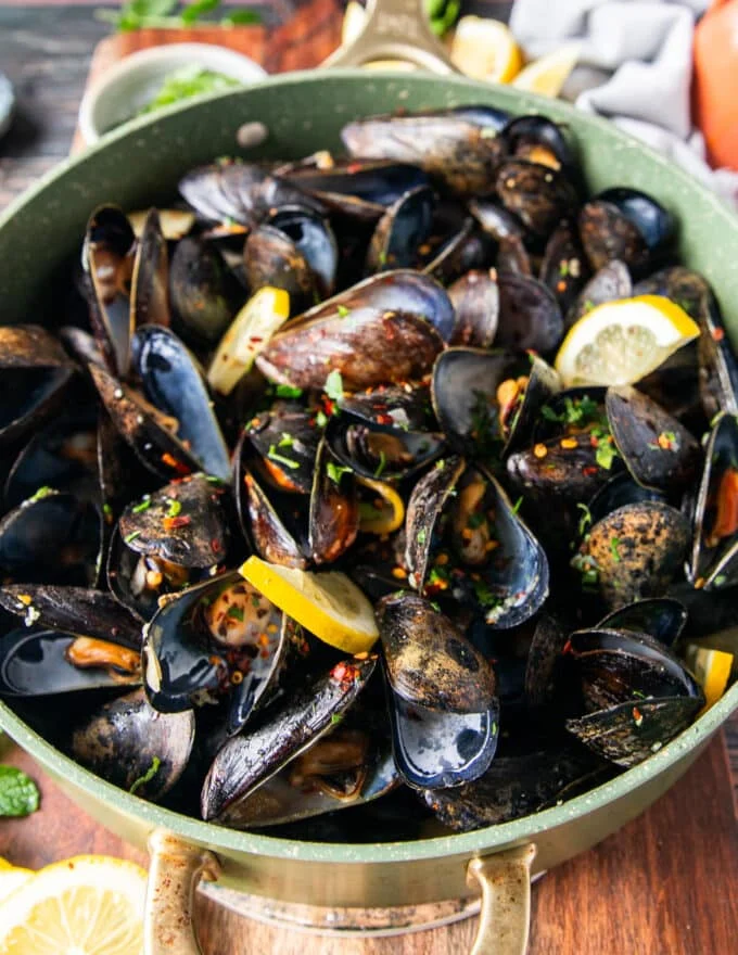 close up of mussels cooking in a large wide pot