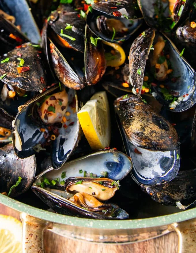 close up of one mussel opened and cooked to show how tender the inside meat is