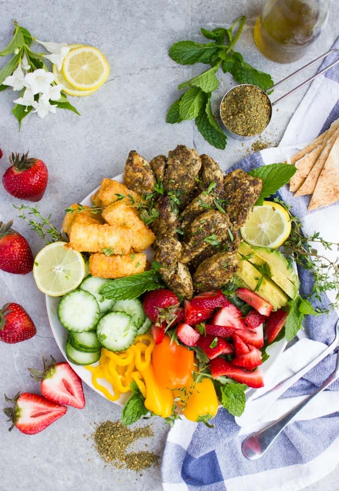 overhead shot of Za'atar Chicken Salad with Fried Halloumi Cheese and seasonal fruit and vegtables
