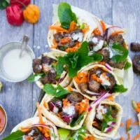 Spicy Harissa Lamb Pita Cones with Tahini Sauce | diced lamb shoulder seared with plenty of garlic and olive oil until charred and tender then seasoned with a fresh pepper Harissa sauce and piled into homemade pita bread pocket. | foodallianceblog.com | #homemade, #easy, #bbq, #spicy, #pita, #pockets, #seared, #protein