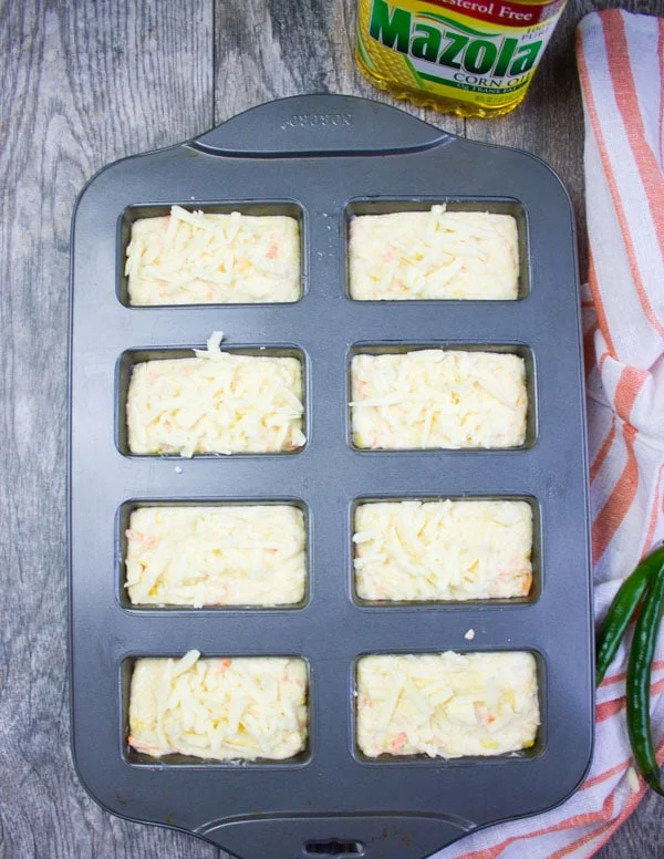 The mini loaf pans loaded with cornbread batter and ready to go to for baking