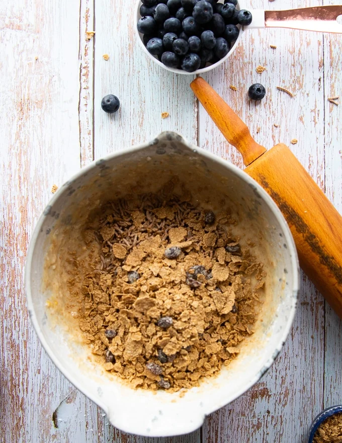 crushed bran cereal added to the bowl of batter