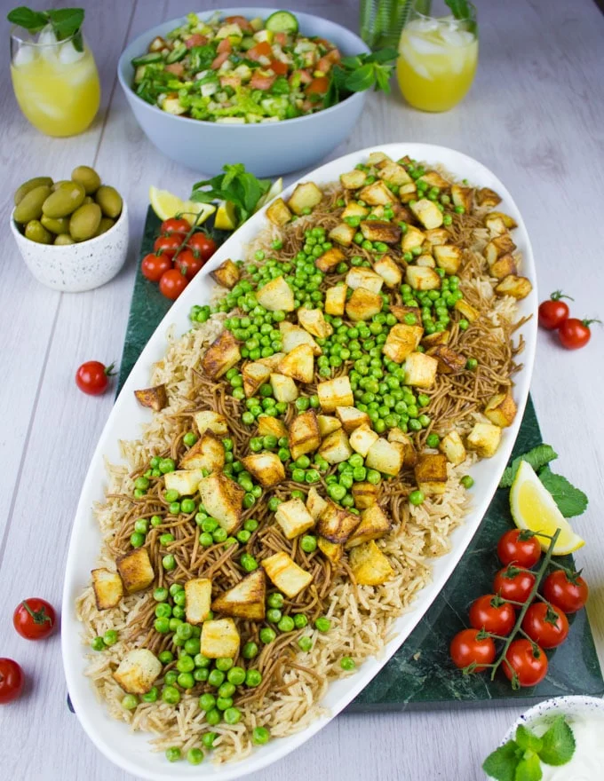 Green peas and roast potatoes topped over the vermicelli noodles for the lamb shoulder recipe