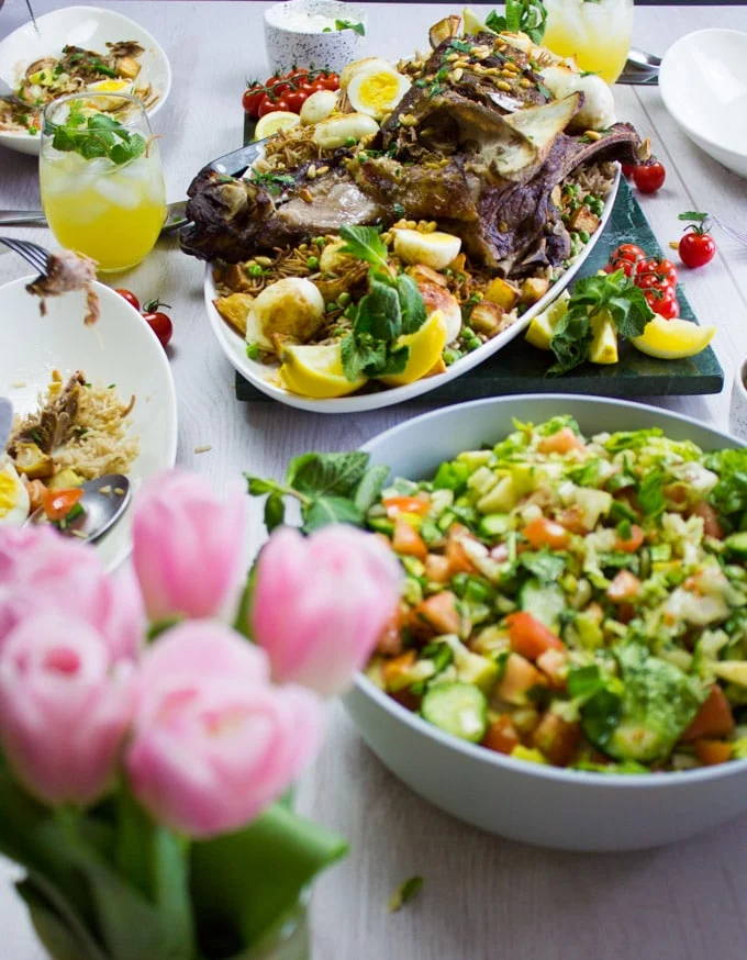 A table set up with flowers, salad and the roast lamb shoulder eaten up and enjoyed.