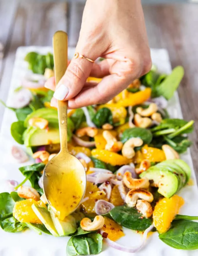 A spoon scooping the orange sald