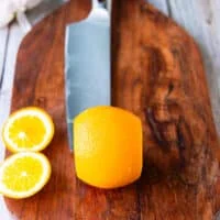 Segmenting the orange the knife slicing tops and bottoms of the orange