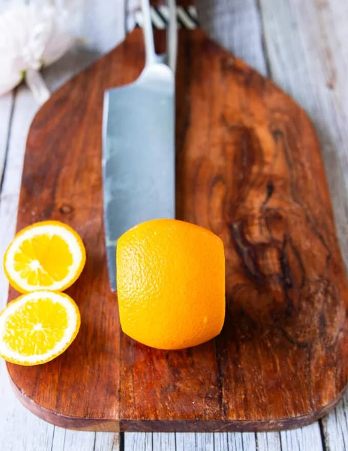 Segmenting the orange the knife slicing tops and bottoms of the orange