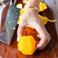 peeled orange showing the membranes and how to slice