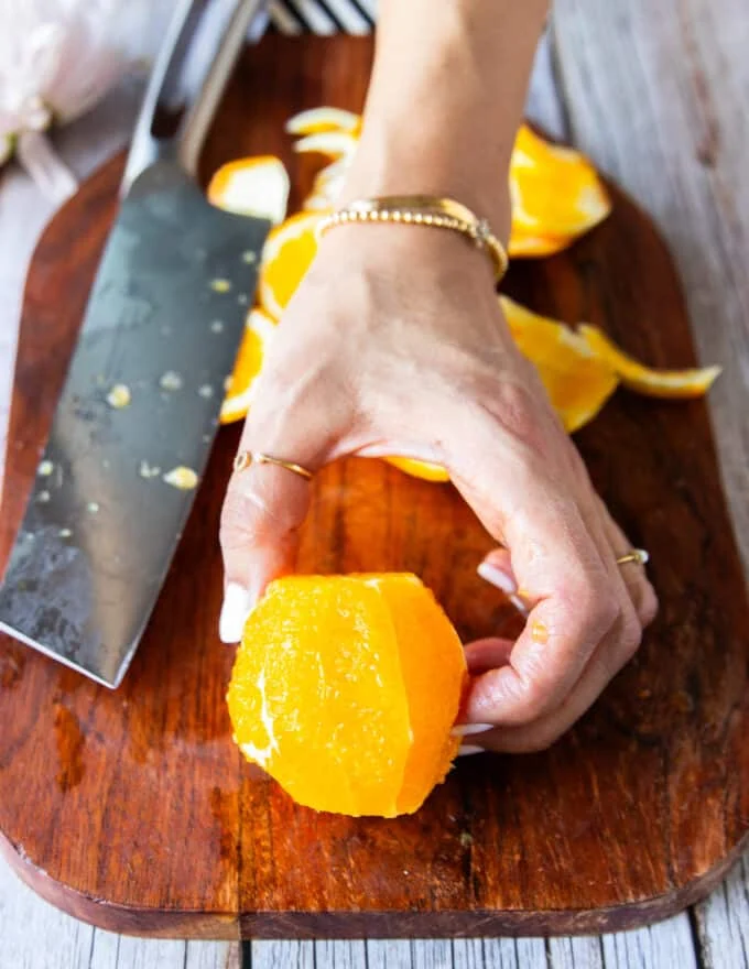 peeled orange showing the membranes and how to slice