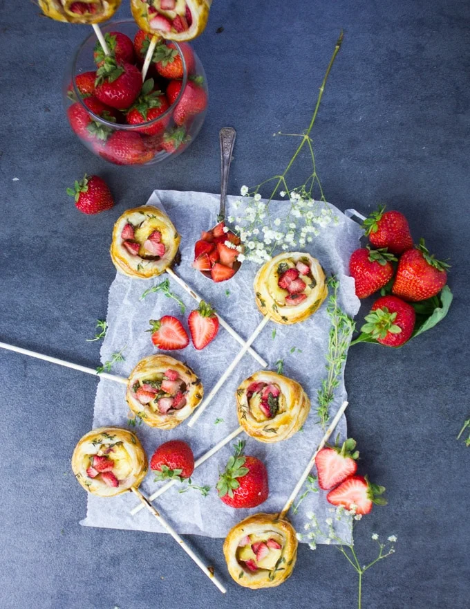 Top view of all the hand pies, flowers and extra strawberries
