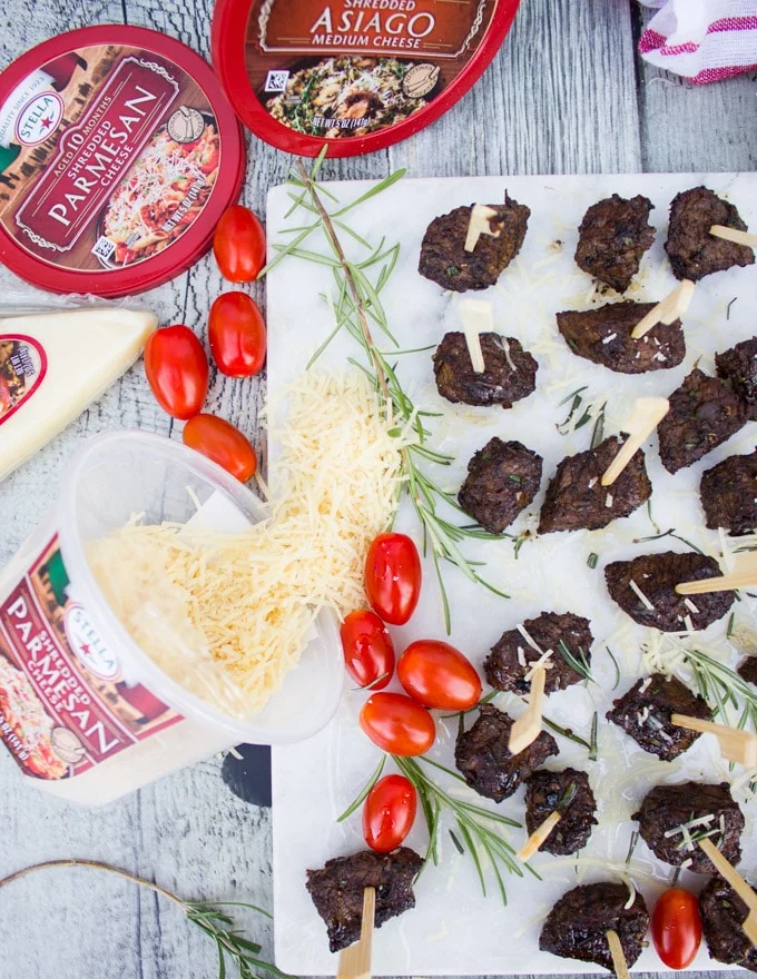 A platter of Steak Bites on a toothpick surrounded by Cheese