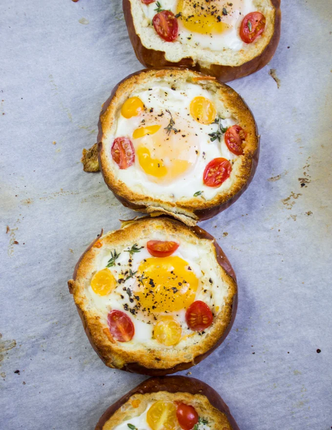 baked eggs in bread bowls out of the oven