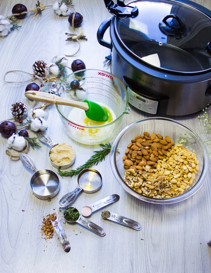 All the ingredients for the spiced nuts: honey, butter, spice, nuts and the crockpot