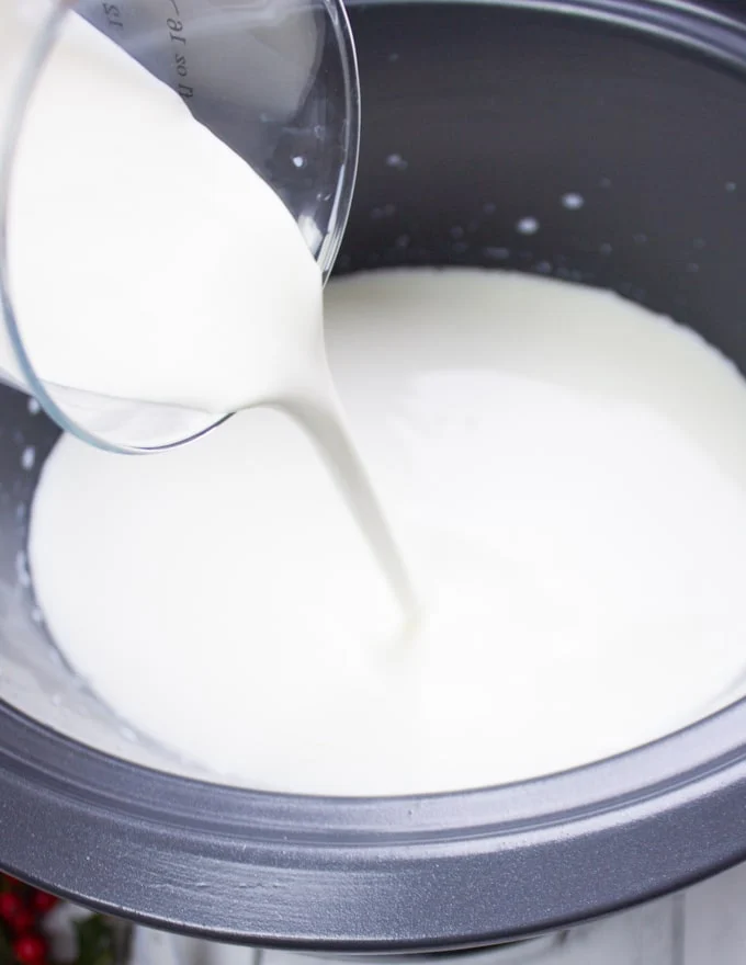 pouring cream into crockpot