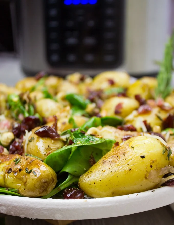 Close up of a potato salad with the crock-pot express at the back