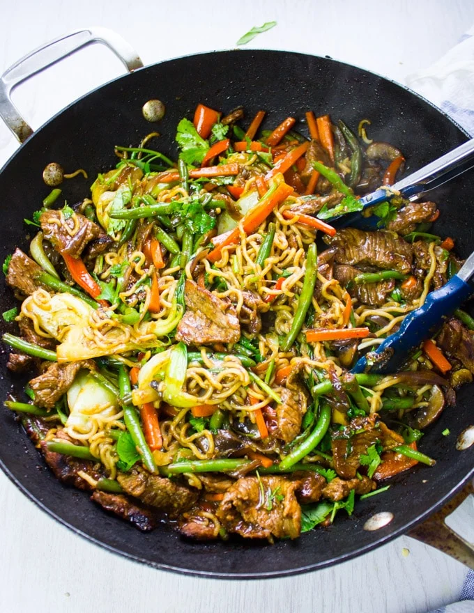 Stir fry ready and fully cooked in the wok with stir fry sauce
