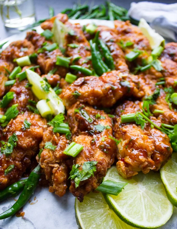 Korean Fried Chicken Strips with lime slices and cilnatro