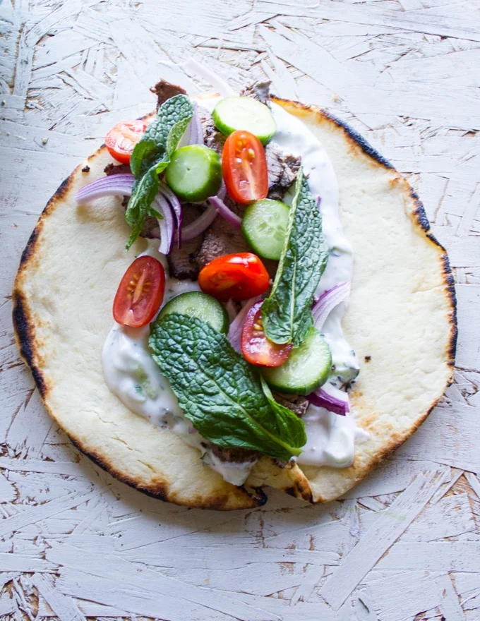 Grilled Lamb and veggies over the Tzatziki Sauce and the gyro sandwich is ready to roll