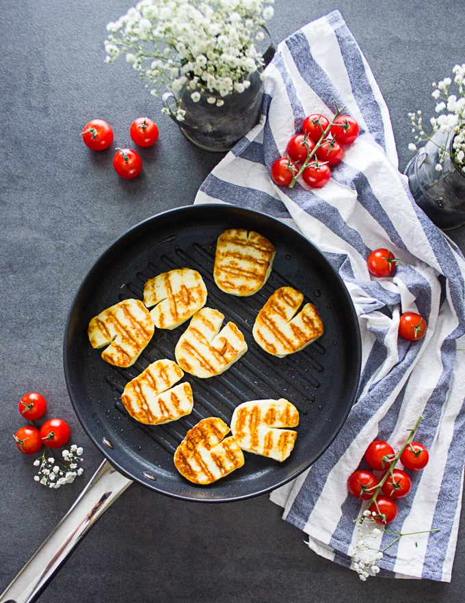 A grill pan with grilled halloumi cheese