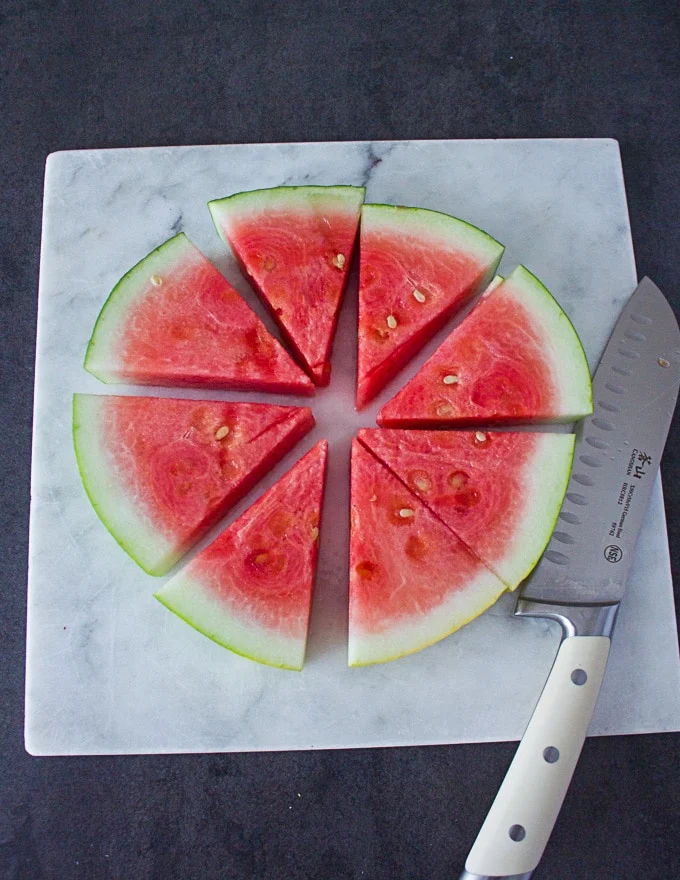 A disc of the watermelon cut up intp eight wedges and ready for the toppings