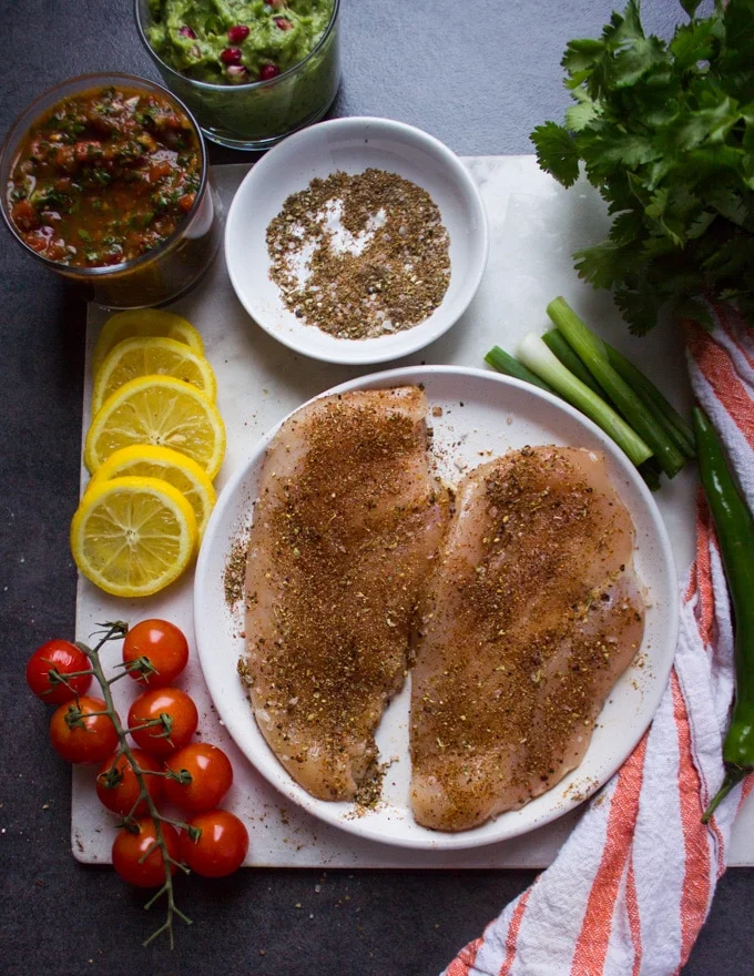 Fully seasoned chicken breasts on both sides liberally with the fajita spice