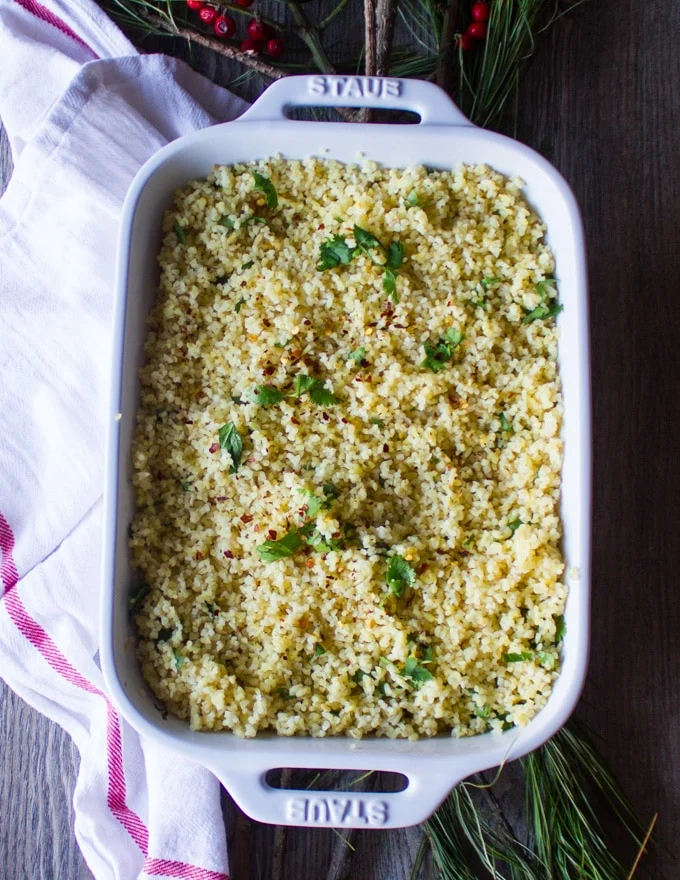 A serving plate with herbed Moroccan couscous read to assemble the lamb