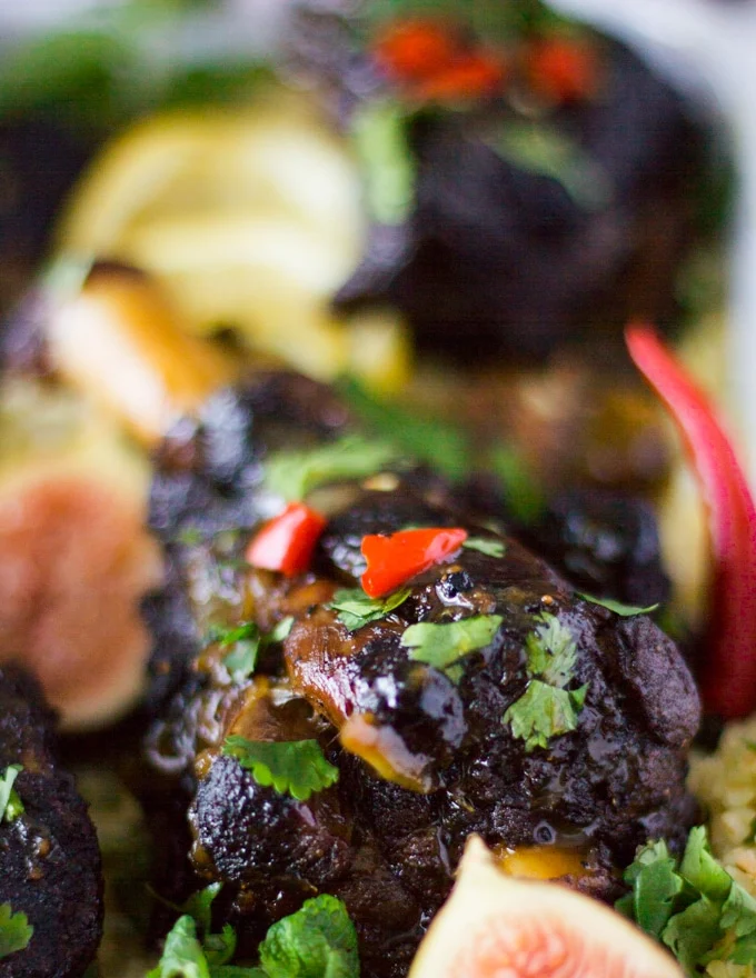 Close up of a roast lamb with Moroccan spice sprinkled with some red chillies