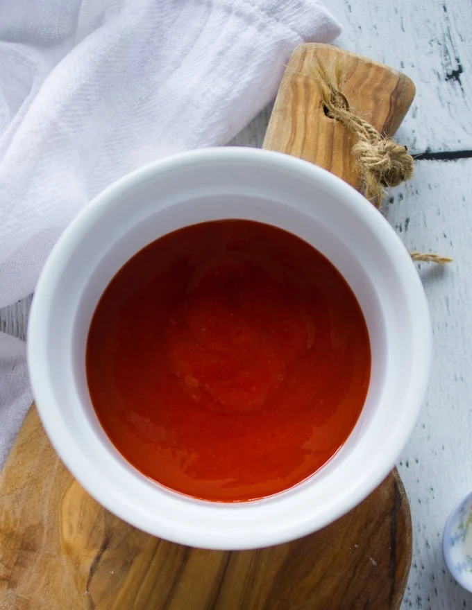 A bowl with some Sriracha sauce