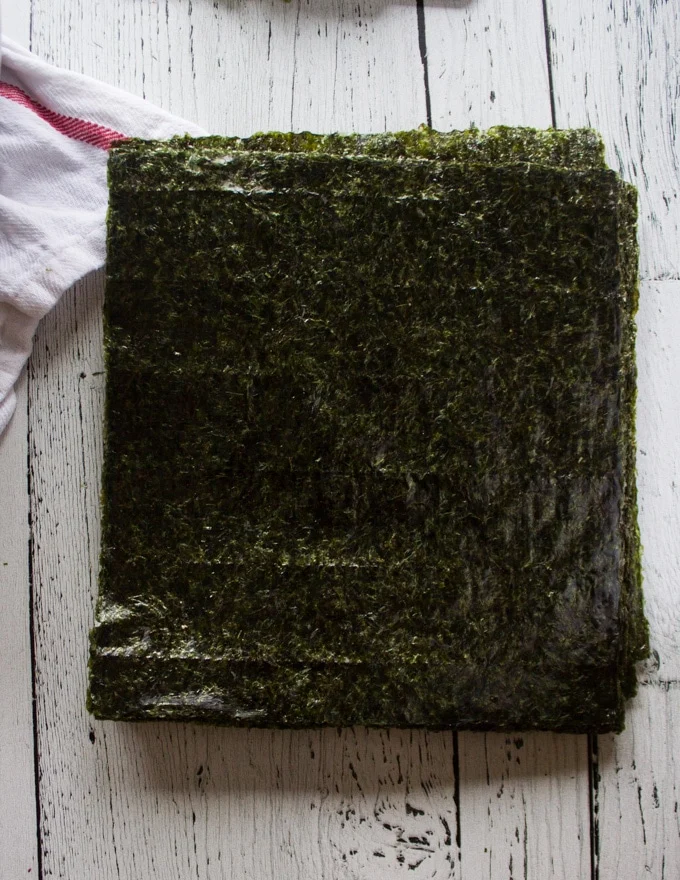 A stack of seaweed sheets to roll the sushi burrito
