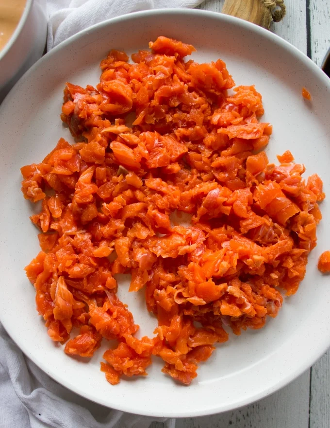 A plate with raw chopped salmon for spucy salmon sushi
