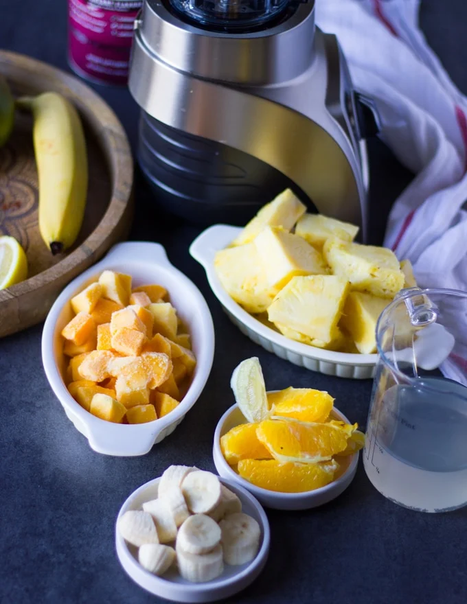 ingredients for the mango banana or pineapple banana layer : frozen mango chunks, pineapple chunks, banana, peeled orange segments and coconut water.