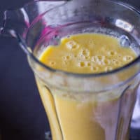 Final mango banana smoothie or pineapple smoothie layer ready in a blender