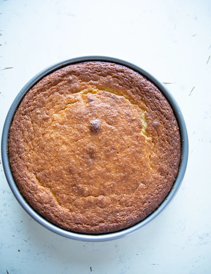 golden yellow olive oil cake right out of the oven and ready for an olive oil brushing