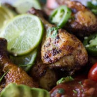 close up of the air fryer chicken leg ready and crispy with lime slices