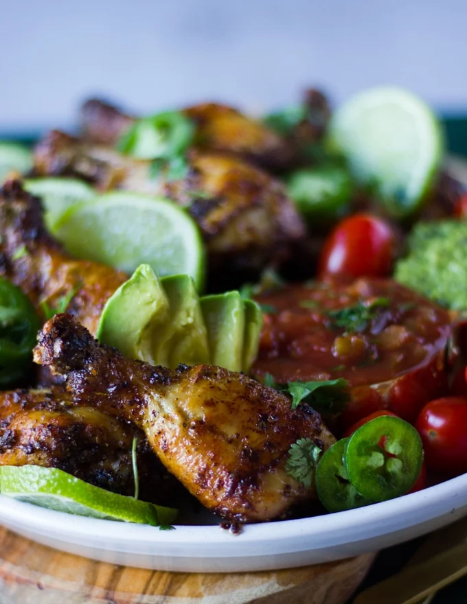 Air fryer chicken legs on a plate and a close up showing one drumstick very crunchy