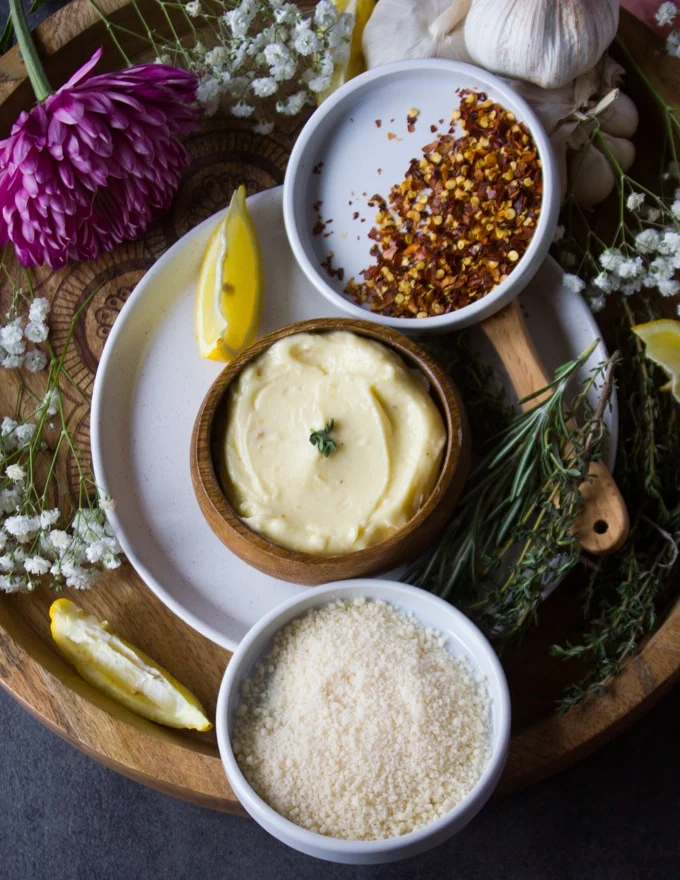 garlic butter sauce for pasta with a bowl of parmesan cheese and some chilli flakes