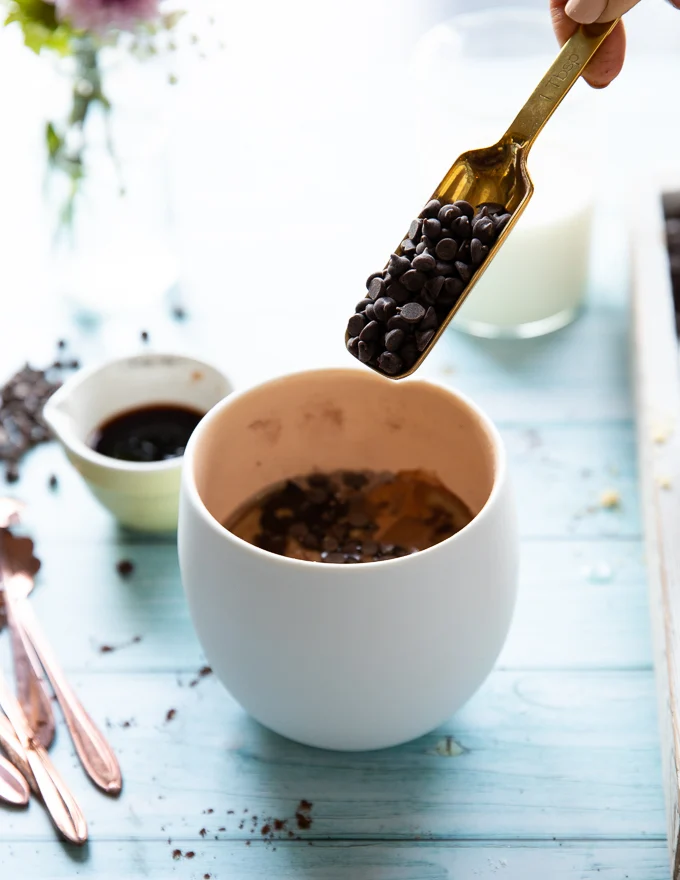 A spoonful of chocolate chips added to the batter to finish off the brownie in a mug ingredients