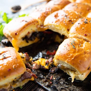 Close up of one Philly Cheesesteak sandwich showing the filling and cheese