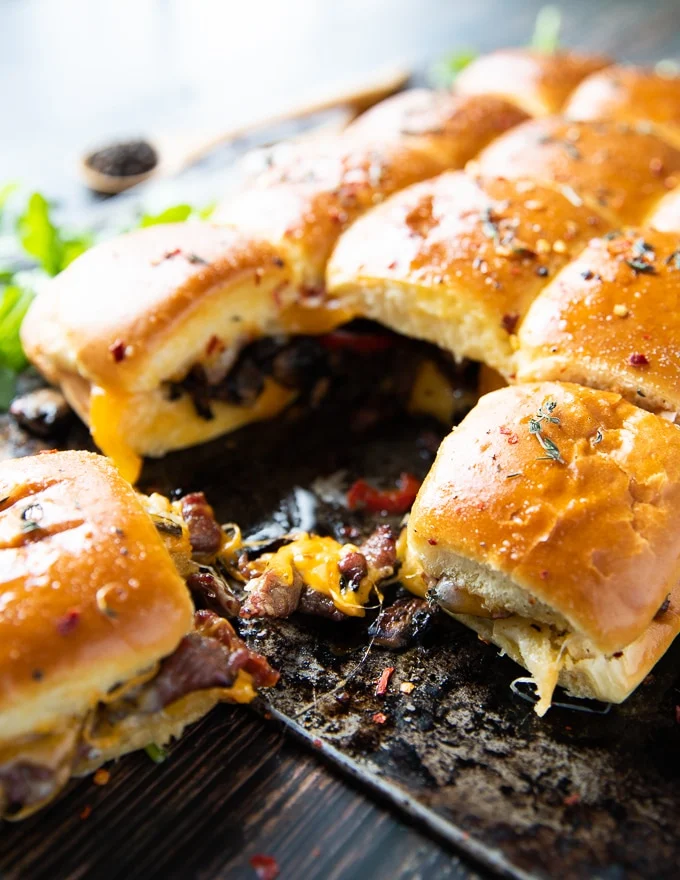 Close up of one Philly Cheesesteak sandwich showing the filling and cheese