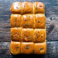 slder bread brushed with melted butter and seasoned, ready to go on the grill or the oven to melt the cheese