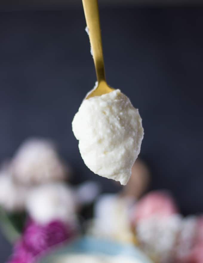 A spoonful of toum garlic sauce lifted up
