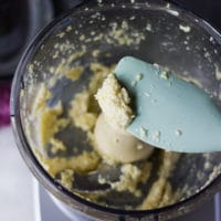 A spatula showing the consistency of the garlic and salt minced well before proceeding with the garlic sauce recipe