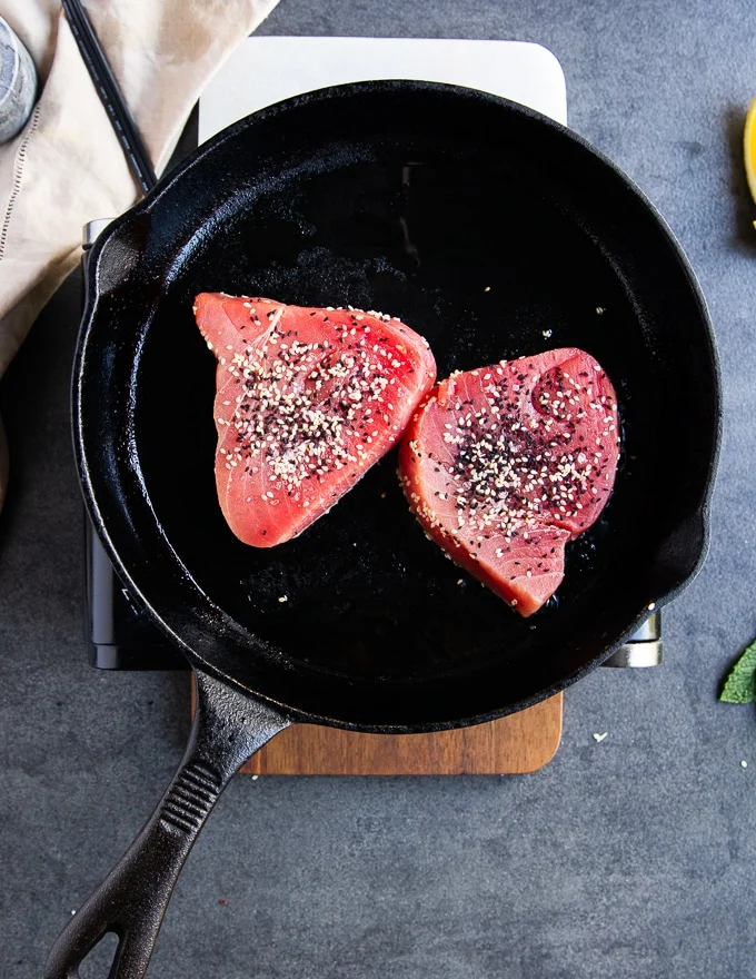 the tuna steaks in a heavy duty cast iton over high heat for seared tuna recipe