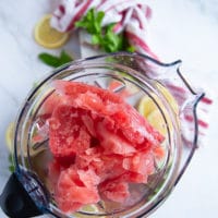 frozen ice cube chunks in a blender bowl ready to make a slush