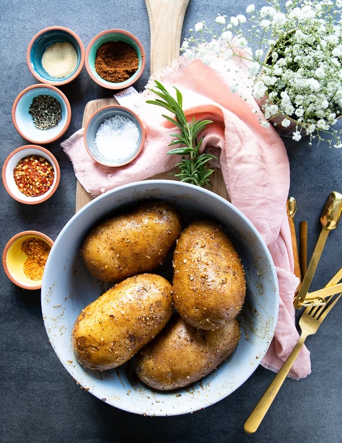 seasoned Russet potatoes drizzled with oil and ready for the air fryer