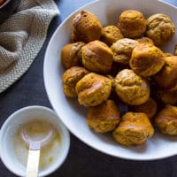 pumpkin donuts out of the oven and toassed in melted butter ready for the cinnamon sugar coating