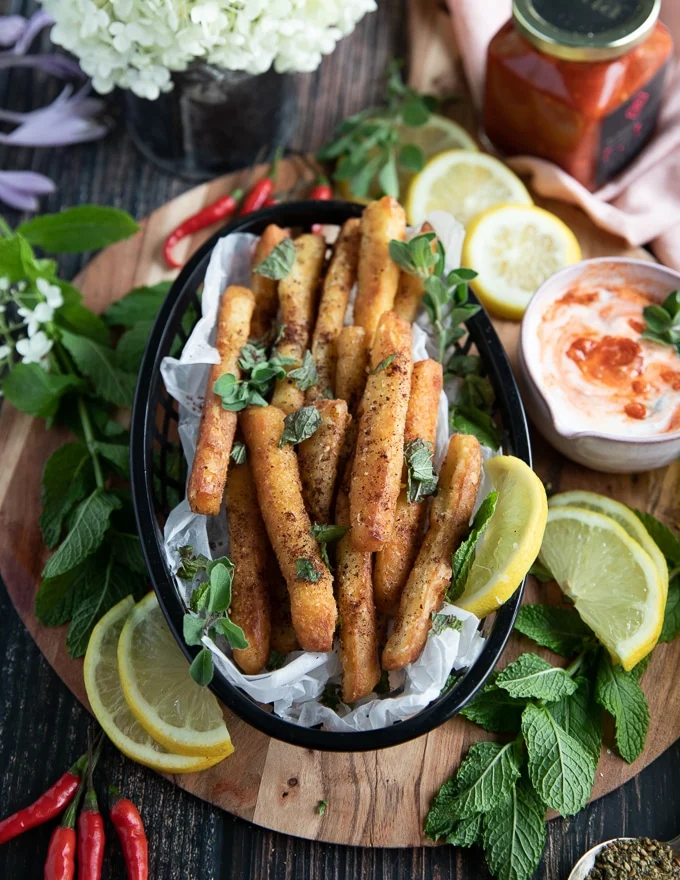 A basket of halloumi fries served with a squeeze of lemon juice and fresh mint